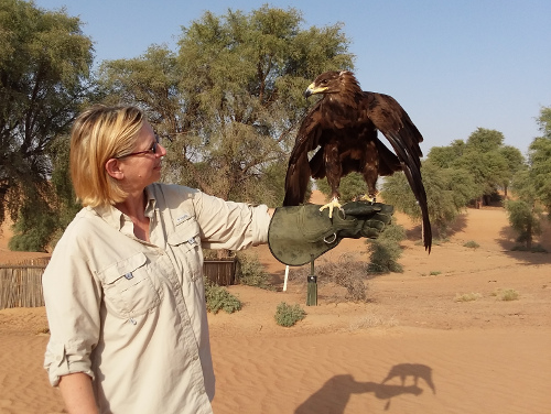 Leslie holding a greater spotted eagle.