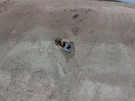 Joe digging high on the side of a hill.