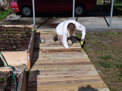 Leslie screwing down the new walkway treads.