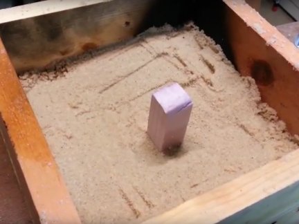 Packing the lost foam mold in sand.