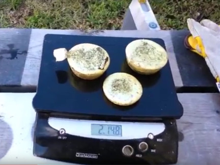 Three newly cast ingots of brass.