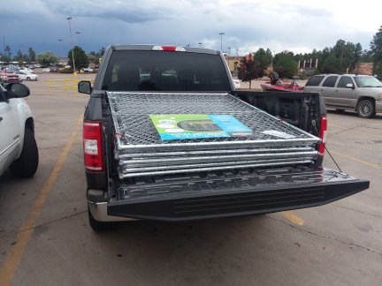 The truck with dog kennel sections loaded in it.