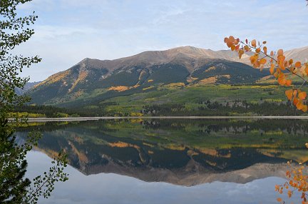 Mountains mirrored in a calm lake.