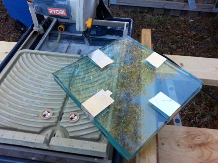Two sheets of glass taped together ready to have the corners cut off.