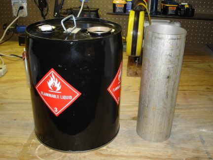 A 5 gallon metal drum and a stainless steel tube.