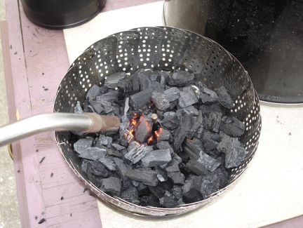 Lighting the charcoal.