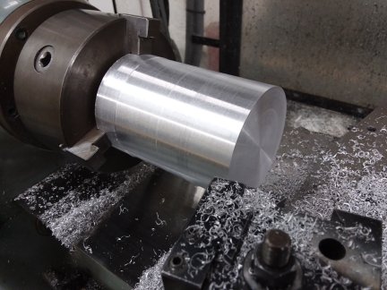 The bean can casting all cleaned up on the lathe.